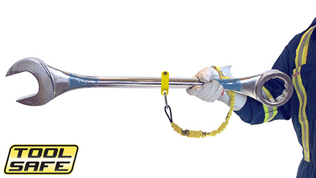 Man holding large wrench with ToolSafe® Clamp and Wrist Lanyard.